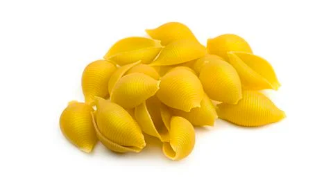 Uncooked shell pasta on white background. Stock Photos
