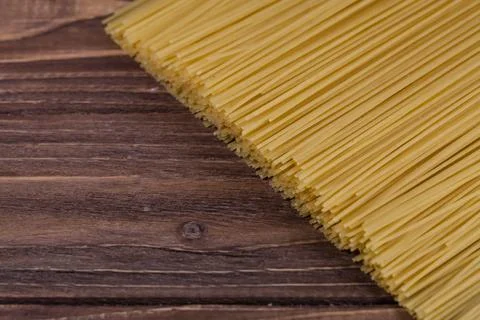 Uncooked spaghetti lie on a diagonal direction Stock Photos