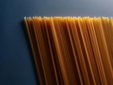Uncooked spaghetti pasta strands creating a textured pattern and culinary b.. Stock Photos