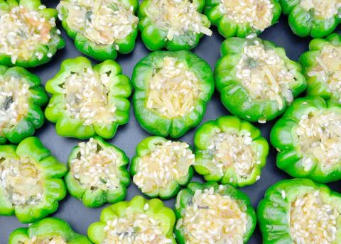 Uncooked stuffed peppers Stock Photos