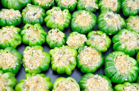 Uncooked stuffed peppers Stock Photos