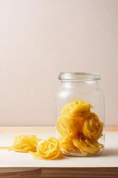 Uncooked tagliatelle pasta. Stock Photos