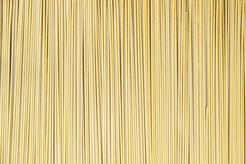 Uncooked thin spaghetti as the background, copyspace. Fotos Stock