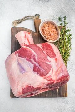 Uncooked veal shank joint with bone on rustic board with fork and spices ra.. Stock Photos