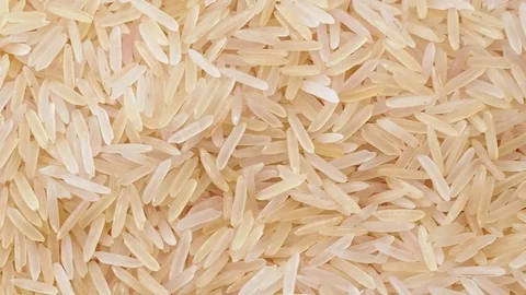 Uncooked white long rice, close shot. Dolly shot of heap of white rice. Texture Stock Footage 127608668