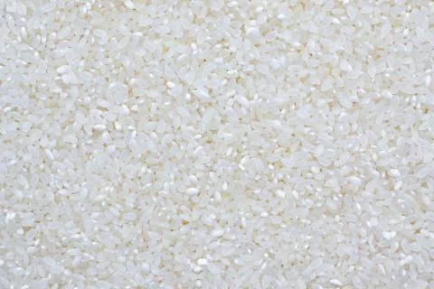 Uncooked white rice texture as abstract white background Stock Photos