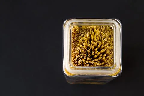 Uncooked,dry various sizes of spaghetti pasta in long glass jar Stock Photos