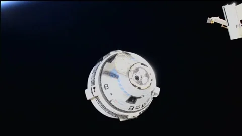 Uncrewed Boeing Starliner performing breakout burn to move away quickly from ISS Stock Footage 284315949