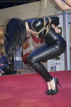 Undefined model poses with a kung fu suit at Erotic Show in Moscow Stock Photos