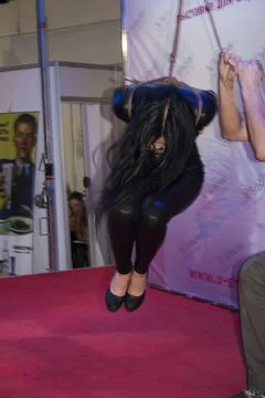 Undefined model posing in the booth at Moscow Erotic Show Exhibition Stock Photos