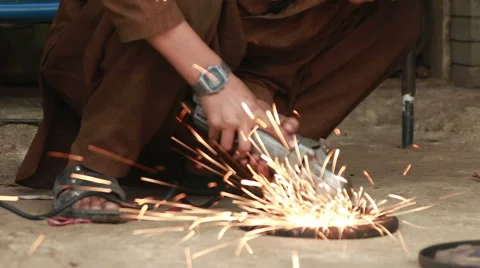 Under age child working with grinding machine Stock Footage 56750154