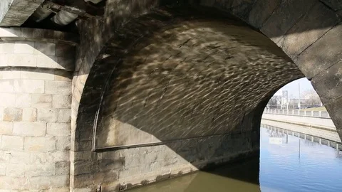 Under the bridge of the city river Stock Footage 73693956