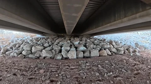 Under Bridge Drainage Area and Rocky Ground Beneath Texas Overpass Stock Footage 334345924