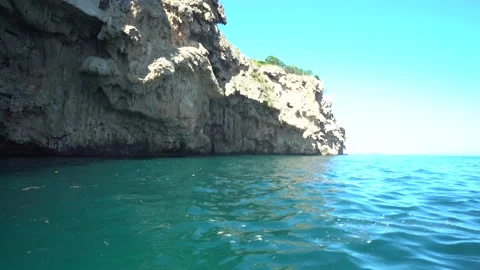 Under the Cliffs on a Boat in Wavey Day Stock Footage 143668964