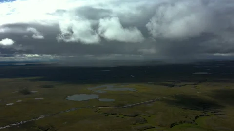 Under clouds. Rain from clouds on plain with lakes. Aerial view. Stock Footage 224104115