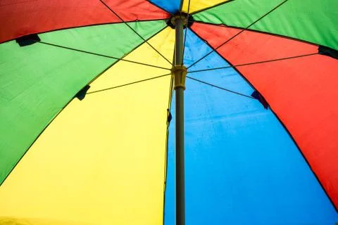 Under colorful umbrella background Stock Photos