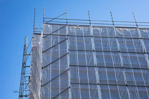 Under construction. Building construction with scaffolding, blue sky backgrou Stock Photos