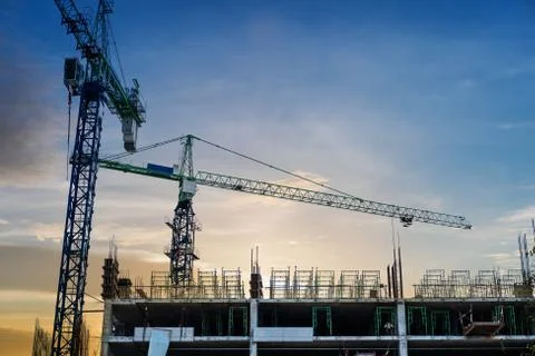 Under construction building with cranes in sunset Stock Photos