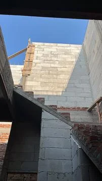 Under construction building wall with lightweight concrete blocks under blue sky Фото