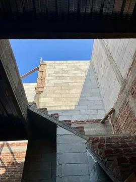 Under construction building wall with lightweight concrete blocks under blue sky 스톡 사진