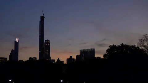The under construction Central Park Tower looms over the NYC Skyline at Sunset Stock Footage 116991809