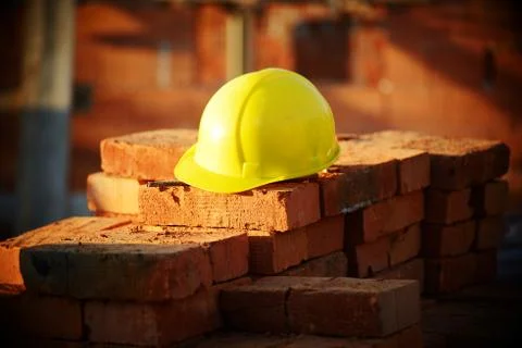 Under construction, helmet and bricks for building site Fotos de archivo