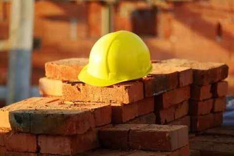 Under construction, helmet and bricks for building site Stock Photos