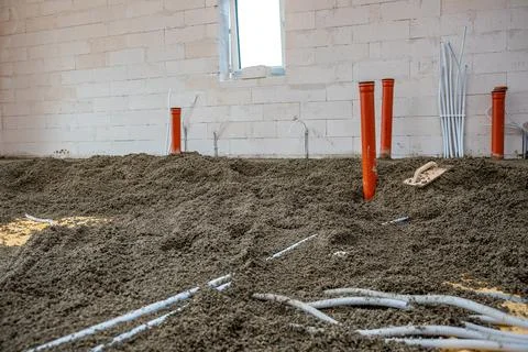 Under Construction Interior with Pipes and Concrete Walls 库存照片