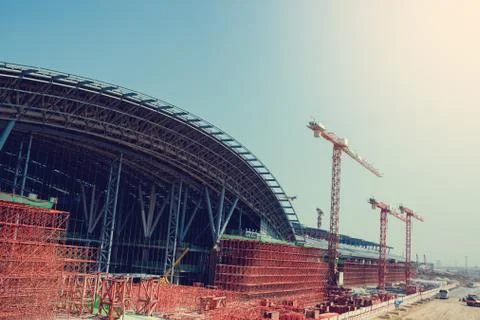 Under construction of metal steel framework outdoors buildings with crane, me Stock Photos