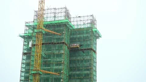 An under construction residential building in a raining day with sound Stock Footage 244457110