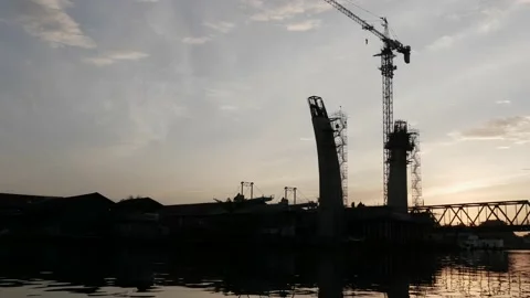 Under construction road bridge silhouette during sunrise Stock Footage 157000120