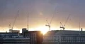 Under Construction Site in London City Center with Building Cranes Golden Sunset 4k or 4k+ Resolution