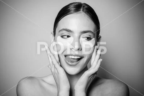 Under eye patches for dark circles and puffiness. Taking care of her skin Stock Photos