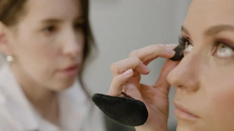 Under-eye shadow corrector, foundation. Makeup artist applies under-eye shadow Stock-Footage 317084613