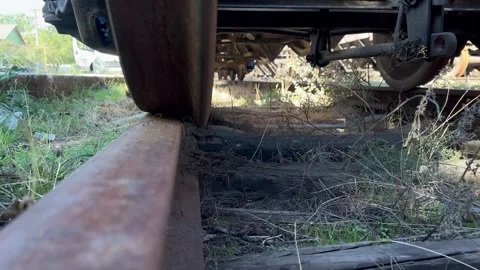 Under Freight Train Wagon Rusty Wheels and Bogie Low Angle Industrial Stock Footage 337332295