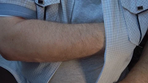 From under his shirt pulls out and cocks a gun Stock Footage 114435578