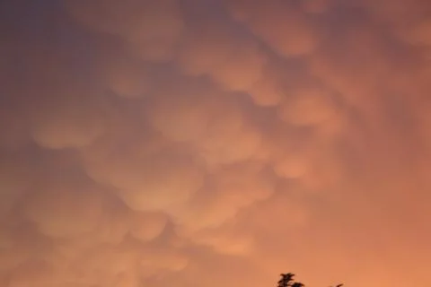 Under lit clouds at sunset Stock Photos