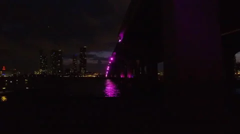 Under Mc Arthur Causeway Bridge from Watson Island with Purple lights 60fps Stock Footage 65506249
