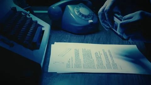Under moody blue light, spy takes photos of classified UFO documents Stock Footage 308998774