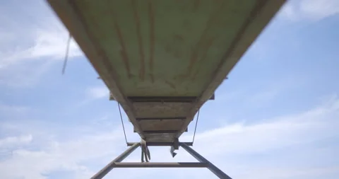 Under a old green manure stacker / Time lapse of the sky with some clouds Stock Footage 131062248