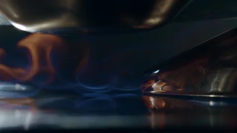 Under the pan burns beautiful fire on the stove. 4K slow motion video Stock Footage 111754693