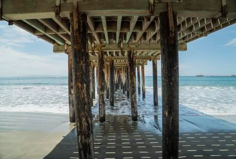 Under Pier by the Ocean Stock Photos