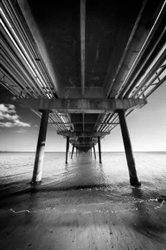 Under the pier in perspective Stock Photos