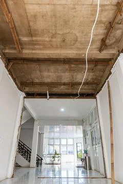 Under renovation with exposed concrete ceiling and wooden supports Stock Photos