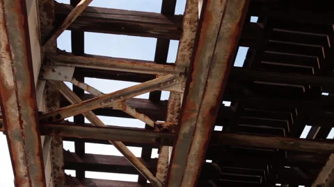 Under rusted and dirty elevated train tracks in Chicago's south side Stock Footage 165966562