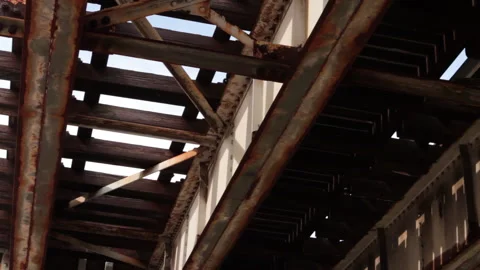Under rusted and dirty elevated train tracks in Chicago's south side Stock Footage 165966633