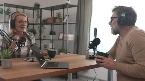Under the shoulder view of mature man and woman record podcast at home Stock Footage 303993895