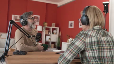 Under the shoulder view of mature man and woman record podcast at home Stock-Footage 303994211