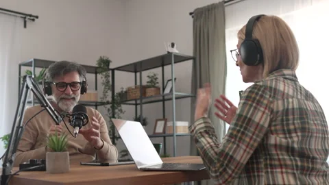 Under the shoulder view of mature man and woman record podcast at home Stock-Footage 303994696