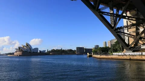 Under Sydney harbour bridge to Circular Quay wharves waterfront of City 4k. Stock Footage 205098877